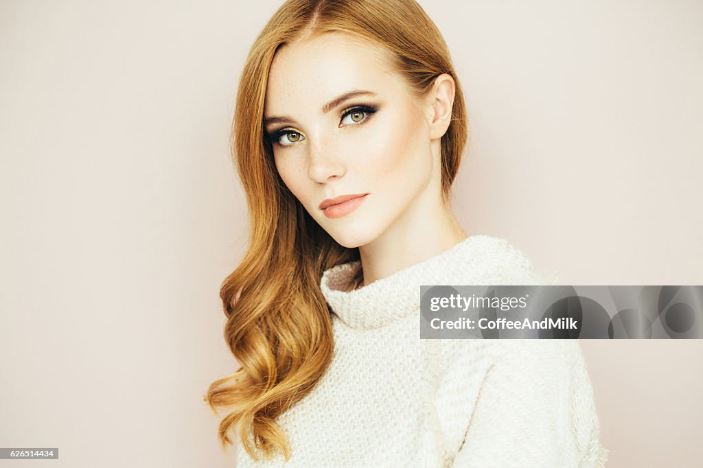 Young beautiful woman on light background