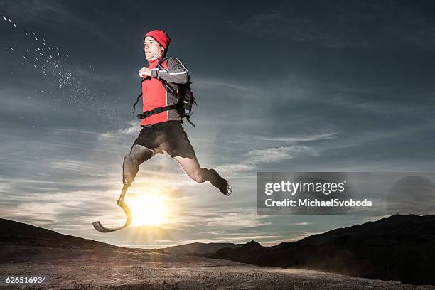 low angle of prosthetic leg running at sunrise - amputee running stock pictures, royalty-free photos & images