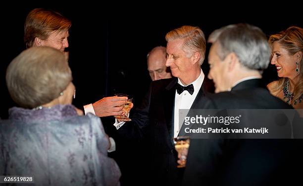 King Philippe and King Willem-Alexander toast during a dinner with Queen Maxima and Princess Beatrix in the Muziekgebouw Aan't IJ Amsterdam on...