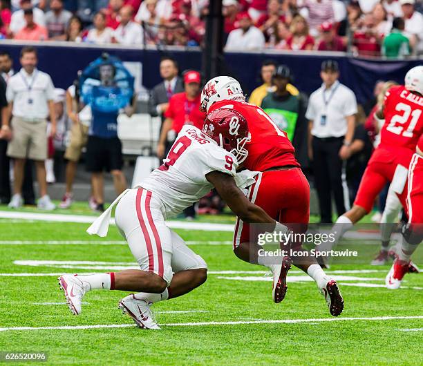 Oklahoma Sooners linebacker Tay Evans stops Houston Cougars quarterback Greg Ward Jr. During the first half of action during a Advocare Texas Kickoff...