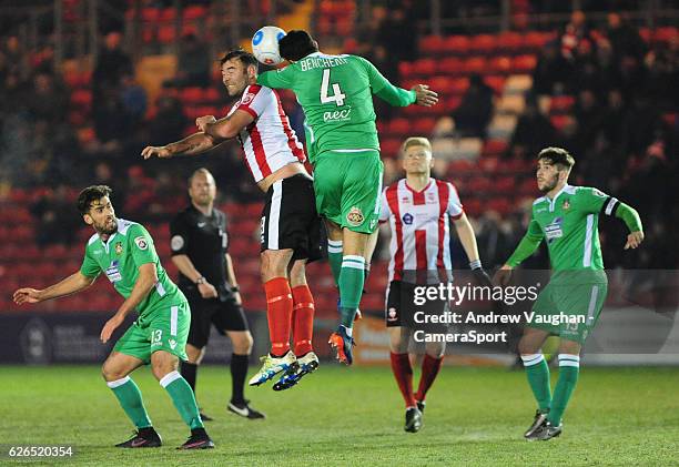 Lincoln City's Matt Rhead vies for possession with Wrexham's Hamza Bencherif during the Vanarama National League match between Lincoln City and...