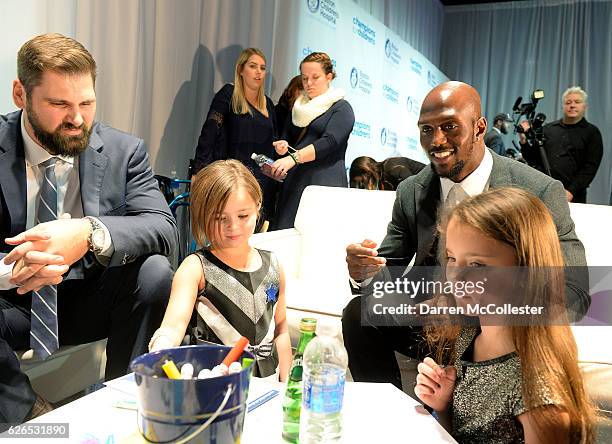 New England Patriots Sebastian Vollmer and Devin McCourty hang out with Isabel and Elia at Champions for Children's at Seaport World Trade Center on...