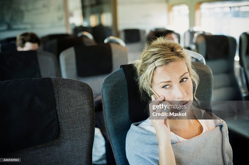 Businesswoman using smart phone in train