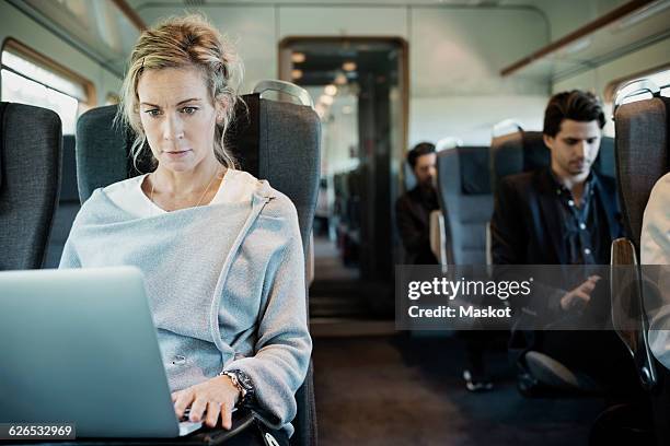 business people traveling in train - trein stockfoto's en -beelden