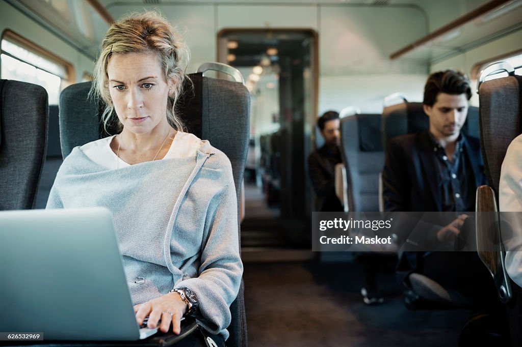 Business people traveling in train