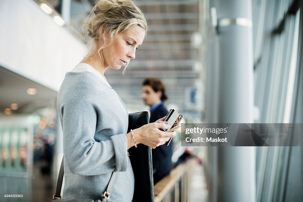 Side view of businesswoman using smart phone at airport