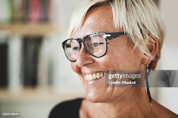 happy industrial designer looking away at home - happy face glasses stockfoto's en -beelden