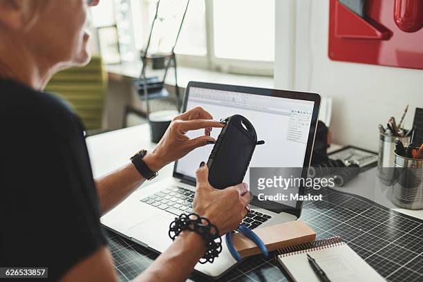 midsection of industrial designer working on product at home office - product design stock pictures, royalty-free photos & images