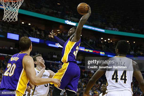 Julius Randle of the Los Angeles Lakers dunks over Omer Asik of the New Orleans Pelicans during the second half of a game at the Smoothie King Center...