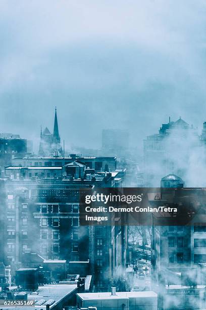 usa, massachusetts, boston, steam above buildings in winter - boston snow stock pictures, royalty-free photos & images