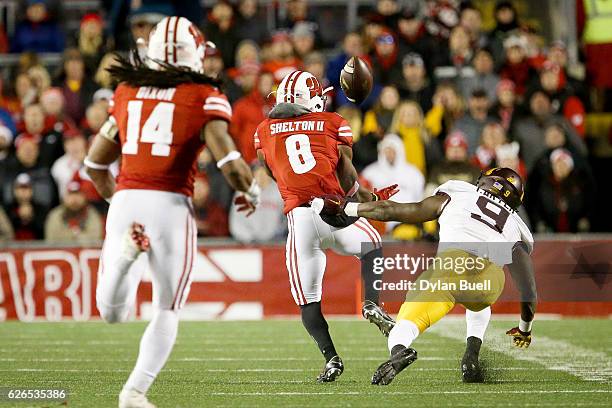 Sojourn Shelton of the Wisconsin Badgers makes an interception past Eric Carter of the Minnesota Golden Gophers in the fourth quarter at Camp Randall...