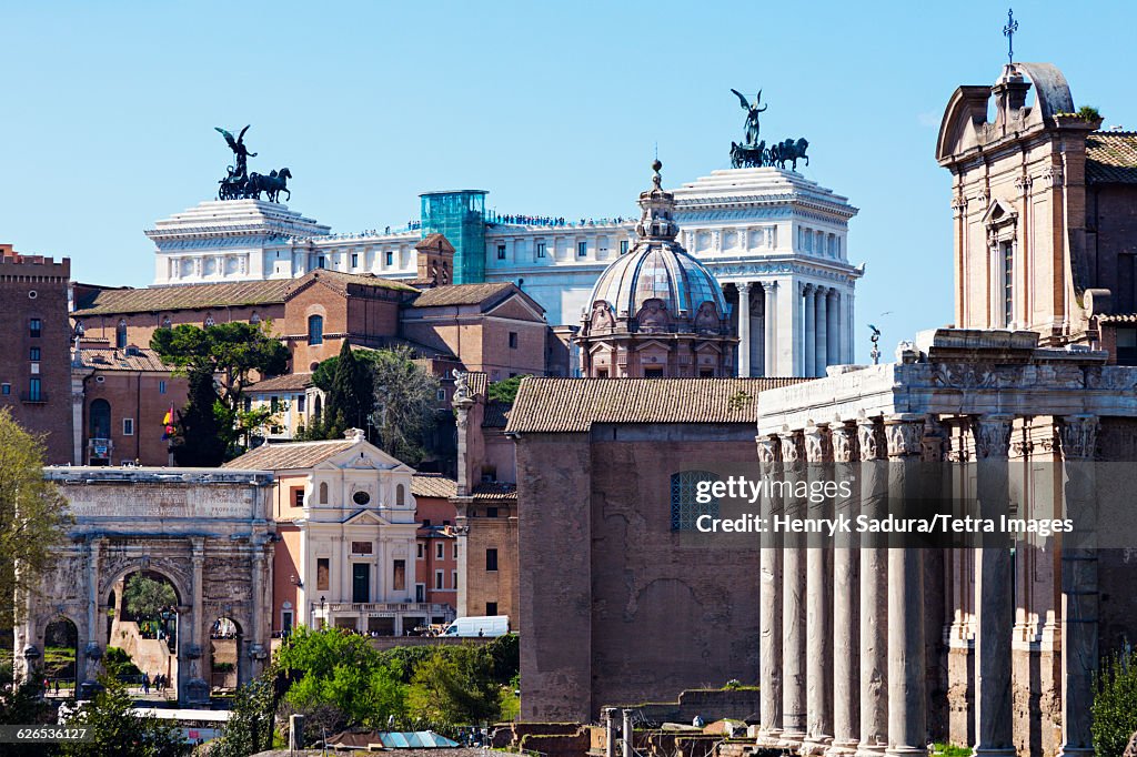 Italy, Lazio, Rome, Roman Forum and Monument of Vittorio Emanuele II against blue sky