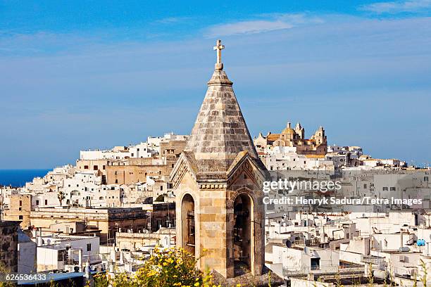 italy, apulia, ostuni, townscape with church tower in foreground - ostuni 個照片及圖片檔