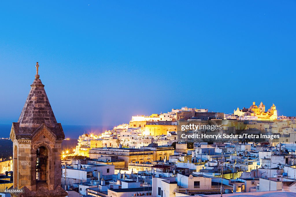 Italy, Apulia, Ostuni, Illuminated townscape at dusk