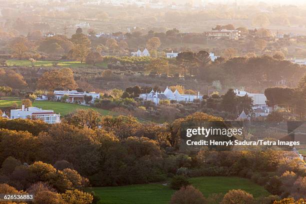 italy, apulia, cisternino, landscape with trulli houses at sunset - cisternino fotografías e imágenes de stock