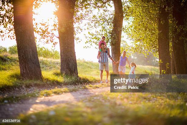 spring family walk - rural couple young stockfoto's en -beelden