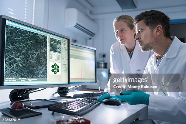 scientists with electron microscope studying metal structure - electron micrograph stock pictures, royalty-free photos & images