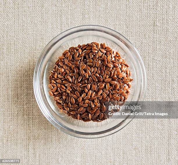 flax seeds in bowl - flax seed stock pictures, royalty-free photos & images