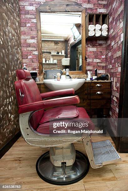 side view of burgundy leather chair in barbershop - kitchen dresser stock pictures, royalty-free photos & images