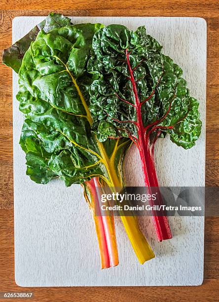 rainbow chard leaves on cutting board - chard stock pictures, royalty-free photos & images