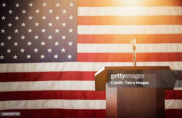 lectern with american flag in background - empty podium flag stock pictures, royalty-free photos & images