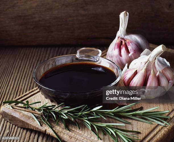 rosemary, garlic bulbs and bowl of balsamic vinegar - aceto foto e immagini stock