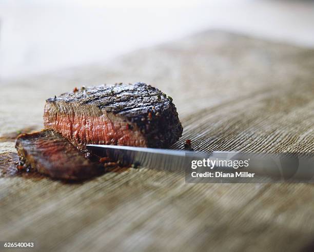 medium rare steak with peppercorns, sliced with knife - steakhouse stock pictures, royalty-free photos & images