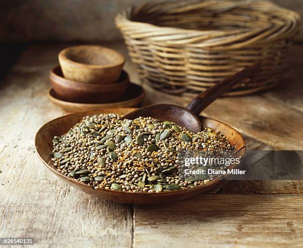 wooden bowl with pumpkin seeds, golden linseeds on hemp seeds on wooden table - hemp seed 個照片及圖片檔