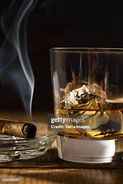 whiskey and cigar on table - hard liquor stock pictures, royalty-free photos & images