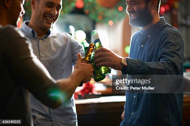 friends in public house making a toast - christmas drinks stockfoto's en -beelden