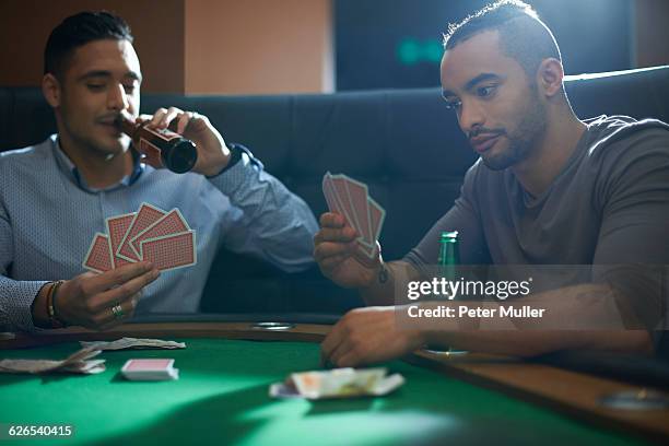 men playing card game for cash at pub card table - card table stock pictures, royalty-free photos & images