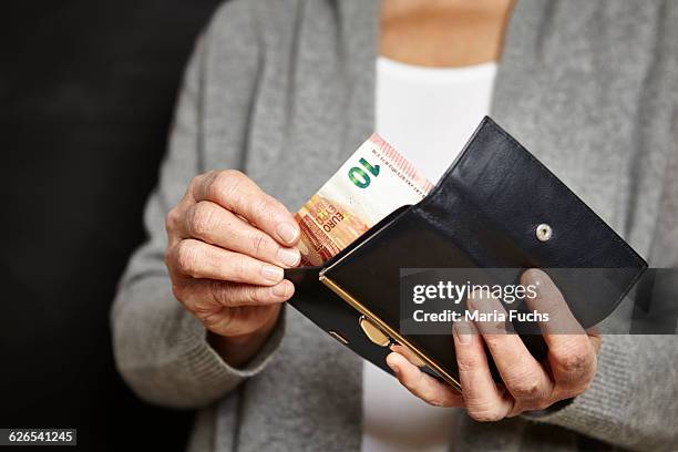 woman getting money out of her wallet - wallet stock pictures, royalty-free photos & images