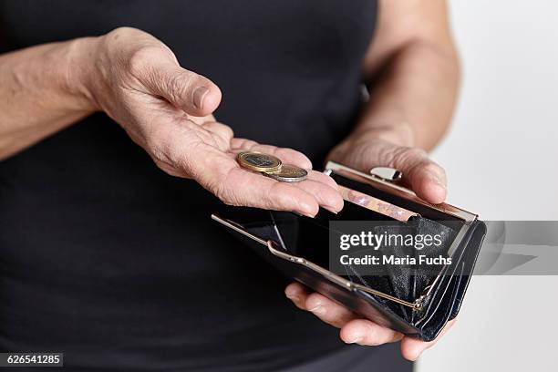 person looking for loose change in coin purse - zählen stock-fotos und bilder