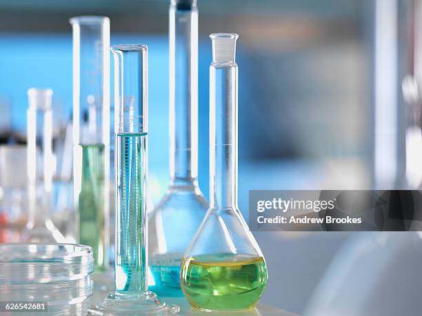 laboratory glassware on lab bench during experiment - boiling flask stock pictures, royalty-free photos & images