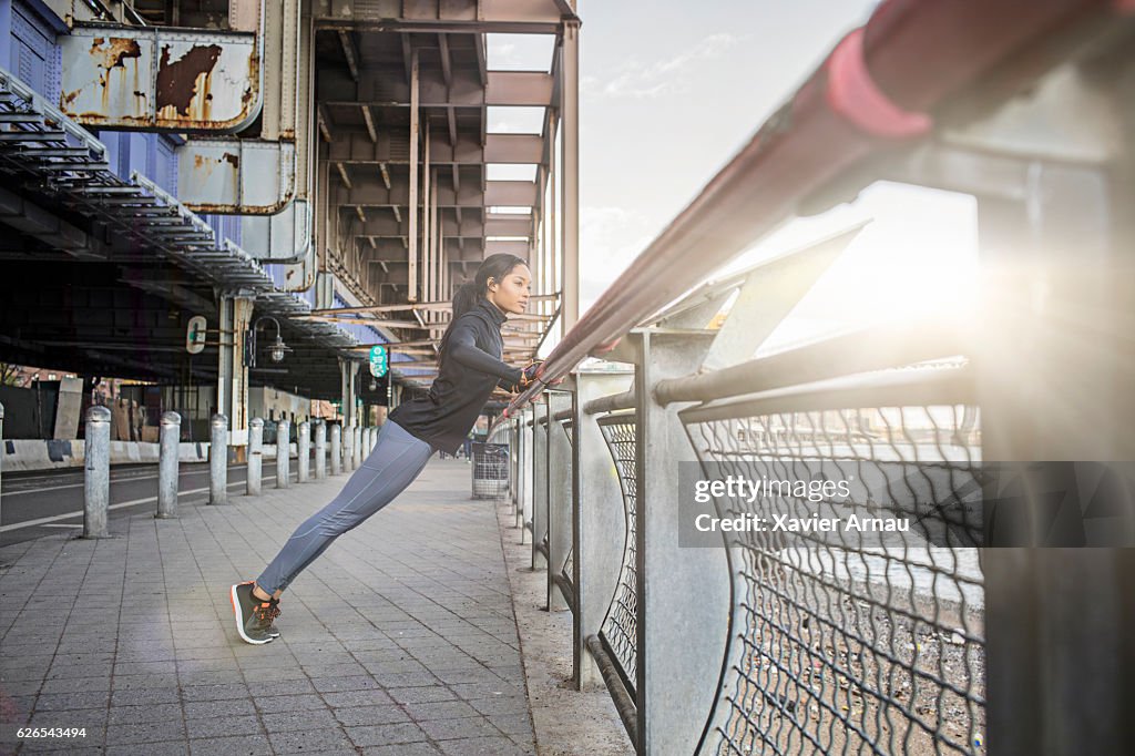 Healthy young woman doing stretching exercise