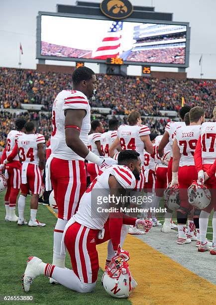 Linebacker Michael Rose-Ivey of the Nebraska Cornhuskers kneels during the National Anthem before the match-up against the Iowa Hawkeyes, on November...
