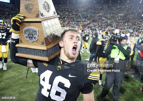 Tight end George Kittle of the Iowa Hawkeyes celebrate with the Heroes Trophy after defeating the Nebraska Cornhuskers, on November 25, 2016 at...