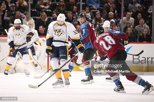 Frederick Gaudreau of the Nashville Predators looks to block a shot by Patrick Wiercioch of the Colorado Avalanche at the Pepsi Center on November...