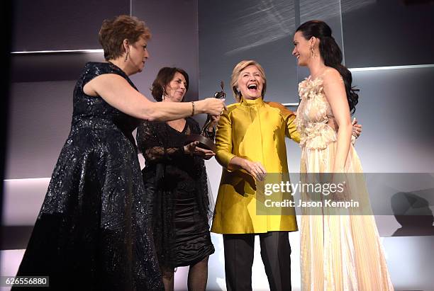 Caryl Stern, Pamela Fiori, and Hillary Clinton present the Audrey Hepburn Humanitarian Award to Honoree Katy Perry during the 12th annual UNICEF...