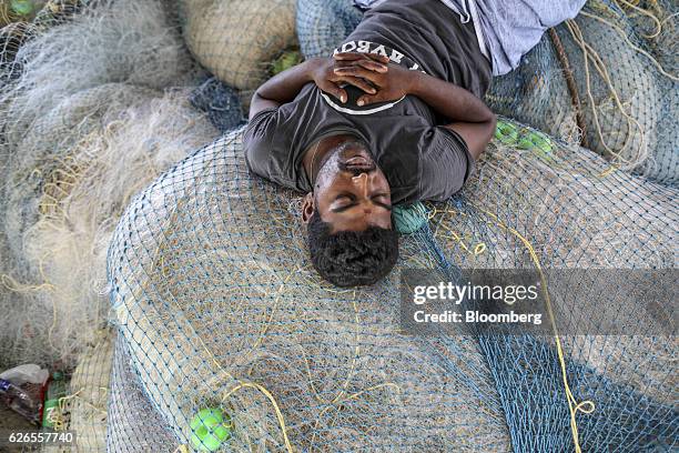 Fisherman sleeps on fishing nets on Velankanni beach near Nagapattinam, Tamil Nadu, India, on Saturday, Oct. 15, 2016. Thousands of fishermen are...