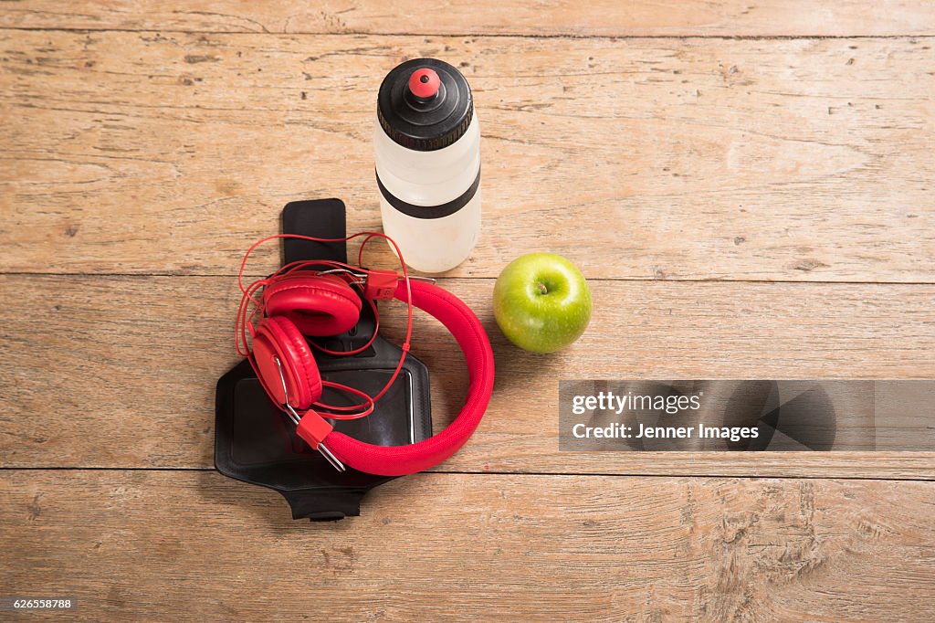 Flat Lay image of Fitness equipment on a wooden floor.