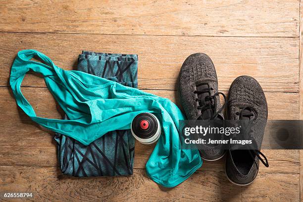 flat lay image of sports clothes and shoes on a wooden floor. - スポーツウェア ストックフォトと画像