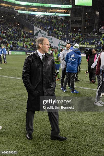 Seattle Sounders head coach Brian Schmetzer walks around the field in the rain after beating the Colorado Rapids at CenturyLink Field on November 22,...