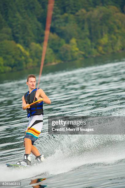 male teen wakeboarding - teen boy shorts stockfoto's en -beelden