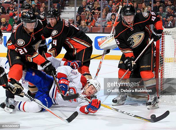 Daniel Carr of the Montreal Canadiens reaches for the puck in front of Chris Wagner Sami Vatanen of the Anaheim Ducks at Honda Center in Anaheim,...