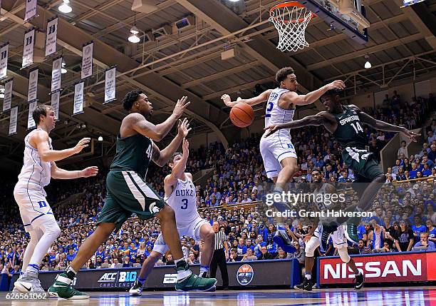 Chase Jeter of the Duke Blue Devils defends on a drive by Eron Harris of the Michigan State Spartans during the game at Cameron Indoor Stadium on...