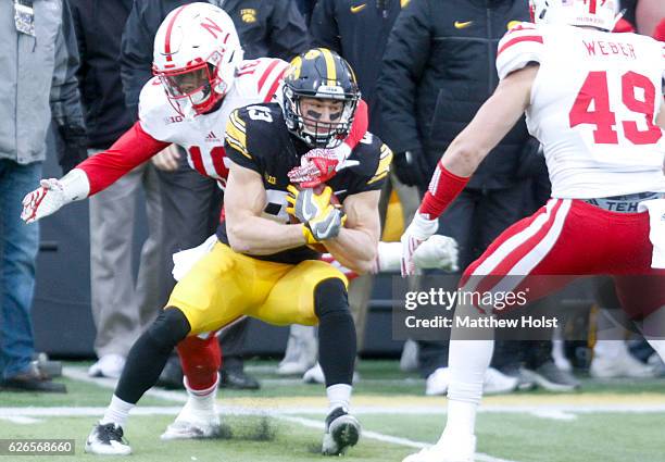 Safety Antonio Reed of the Nebraska Cornhuskers makes a tackle during the first quarter on wide receiver Riley McCarron of the Iowa Hawkeyes on...