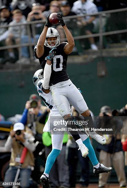 Seth Roberts of the Oakland Raiders catches a touchdown pass over Robert McClain of the Carolina Panthers in the first quarter during an NFL football...