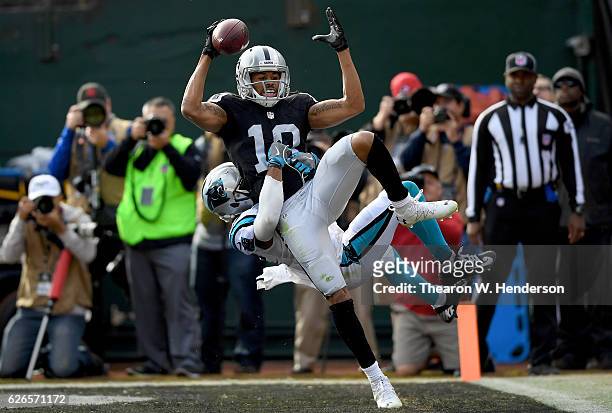 Seth Roberts of the Oakland Raiders catches a touchdown pass over Robert McClain of the Carolina Panthers in the first quarter during an NFL football...