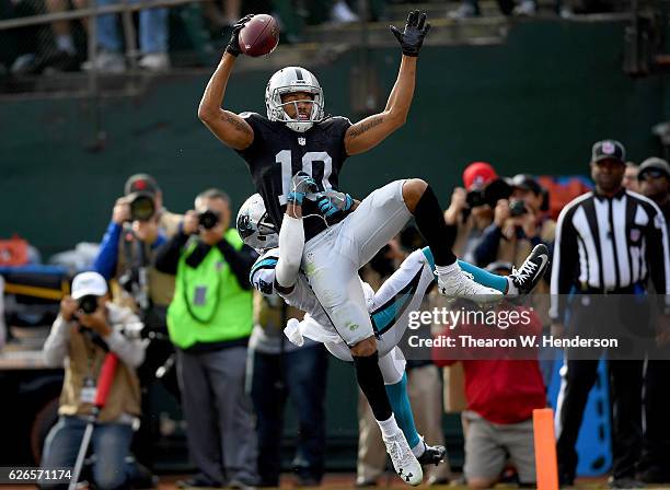 Seth Roberts of the Oakland Raiders catches a touchdown pass over Robert McClain of the Carolina Panthers in the first quarter during an NFL football...